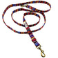 Colorful striped dog leash with gold clasp on a white background