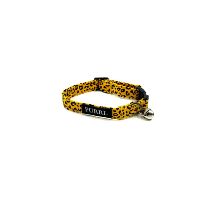 Cute set of cat accessories in yellow and black ochre leopard print fabric. Includes collar with bell, and bowtie and bandana that can thread through the collar