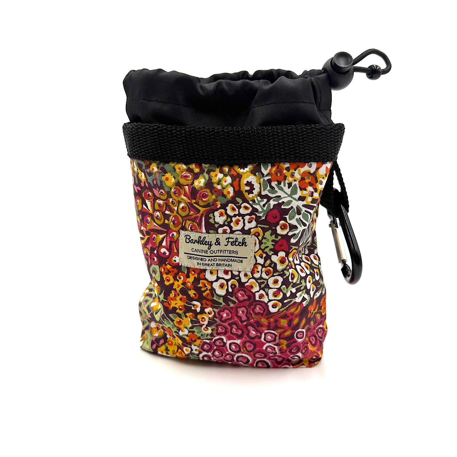 Colorful patterned pouch with black drawstring and carabiner on a white background