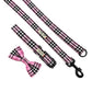 Pink and black checkered dog leash with bow tie on a white background