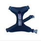 Navy blue dog harness with a purple strap on a white background