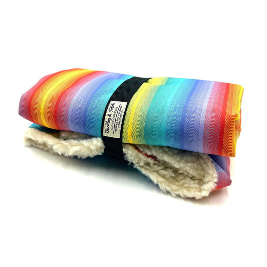 Handmade rolled up settle mat for dogs in a colourful rainbow stripe printed fabric