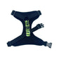 black dog harness with a green and black pattern on a white background
