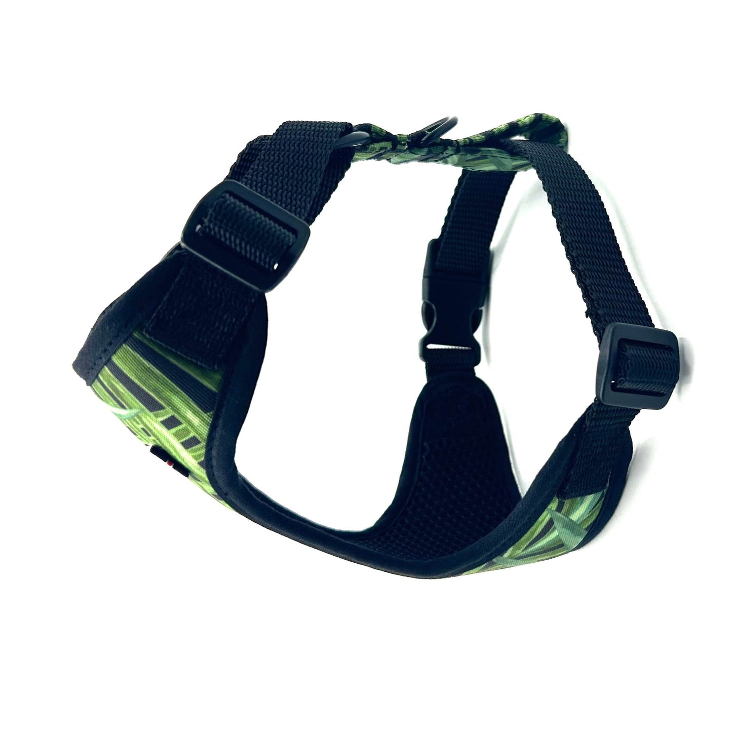 Black dog harness with green pattern on a white background