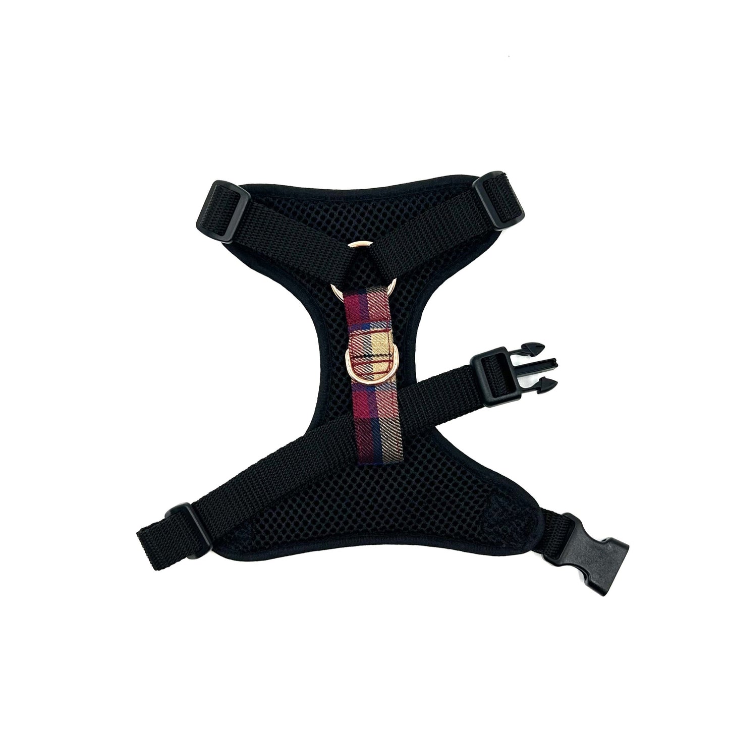 Black dog harness with a colorful plaid strap on a white background
