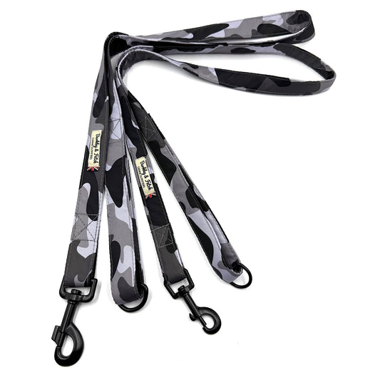 Camouflage-patterned dog leash with black clip on a white background