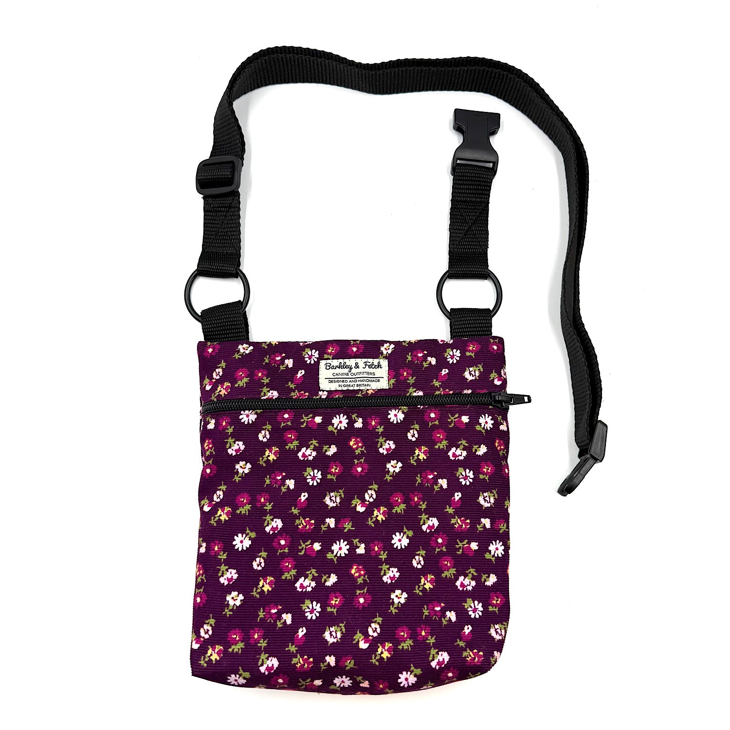 Floral-patterned pouch with a black strap on a white background