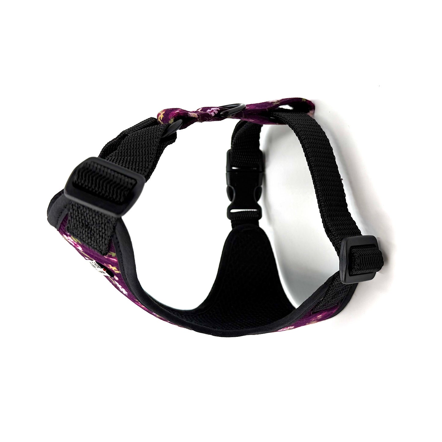 Black dog harness with purple floral pattern on a white background