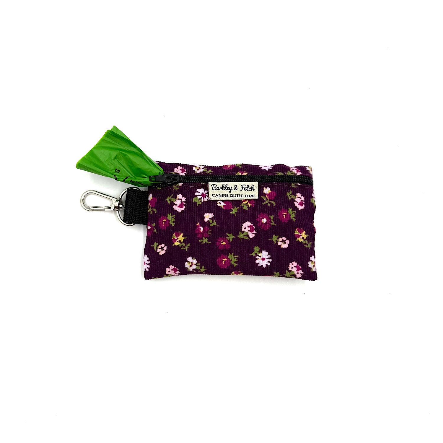 Floral-patterned pet waste bag dispenser with a green bag on a white background