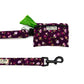 Floral-patterned dog leash and waste bag holder on a white background