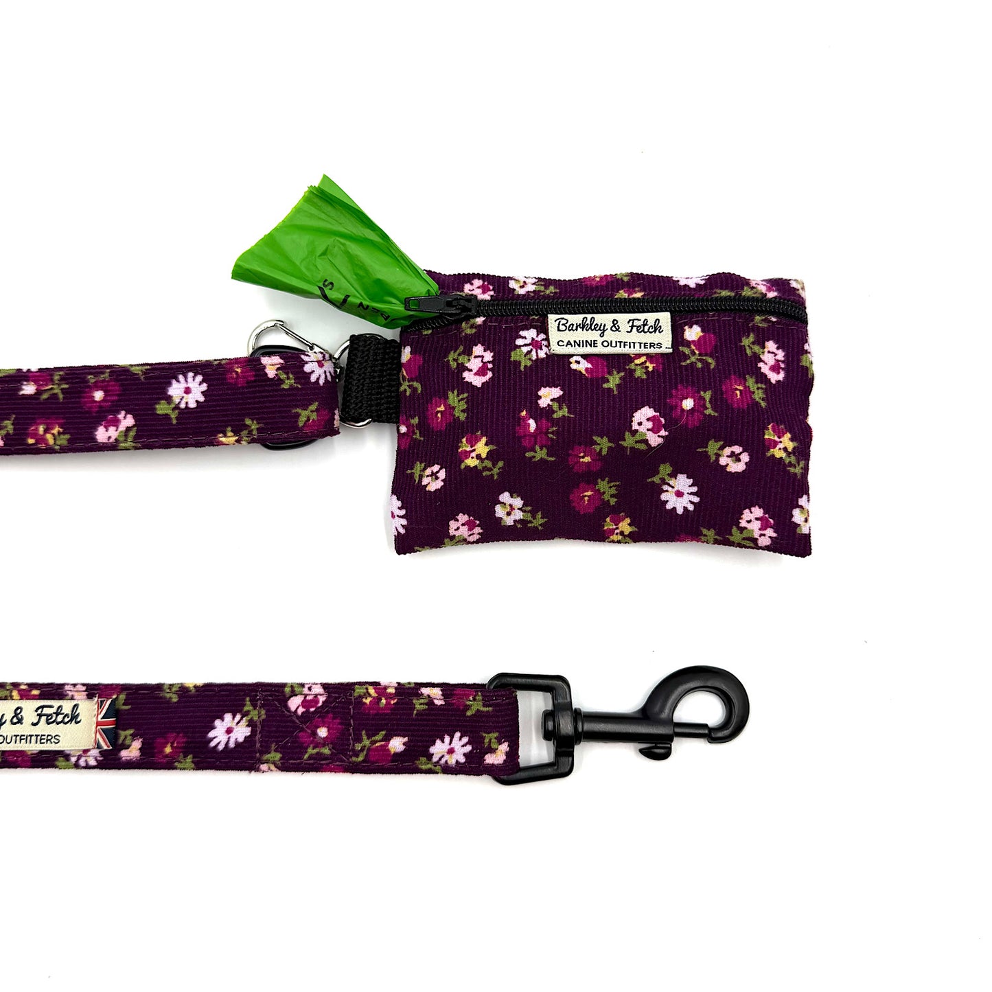 Floral-patterned dog leash and waste bag holder on a white background