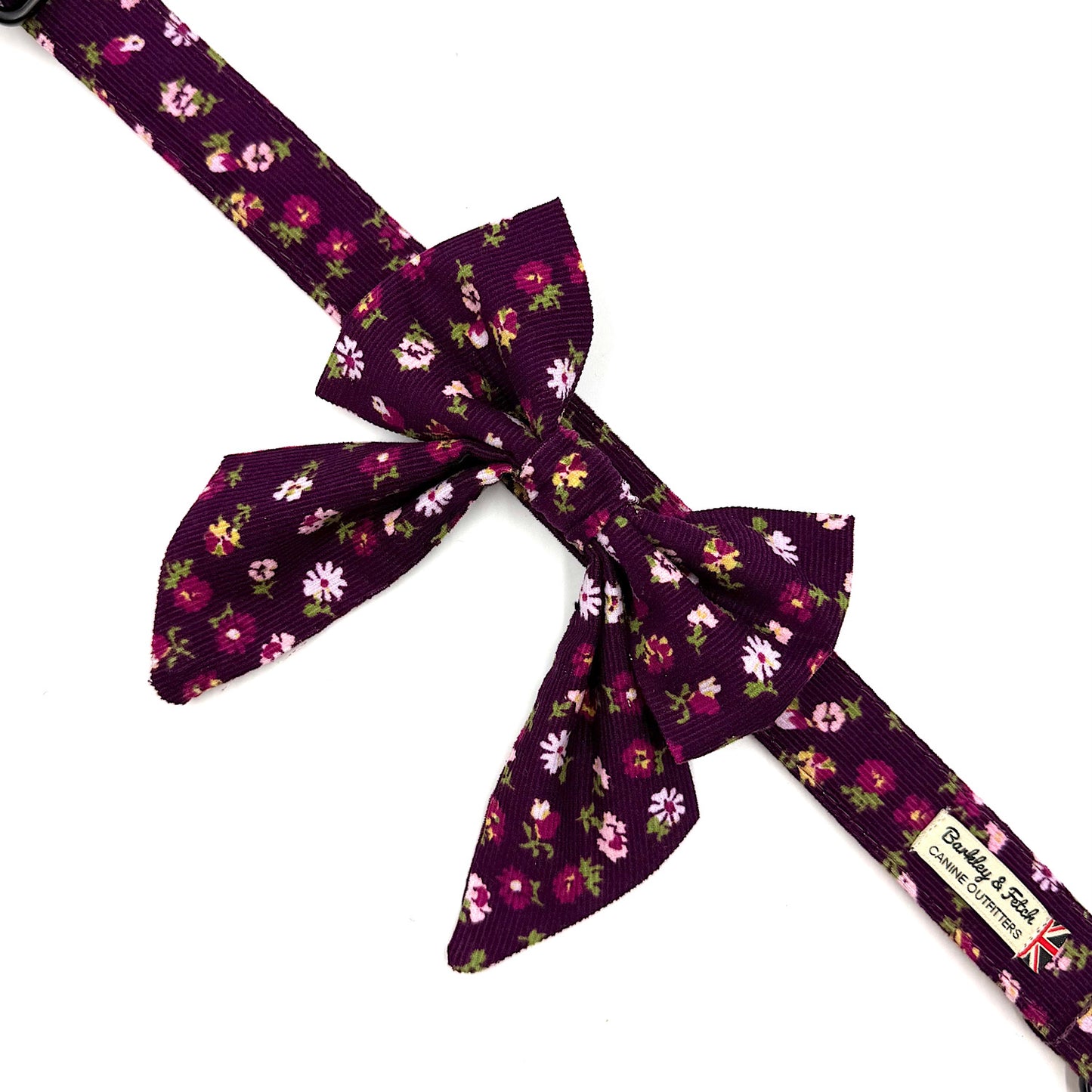 Purple floral-patterned belt with a large bow on a white background