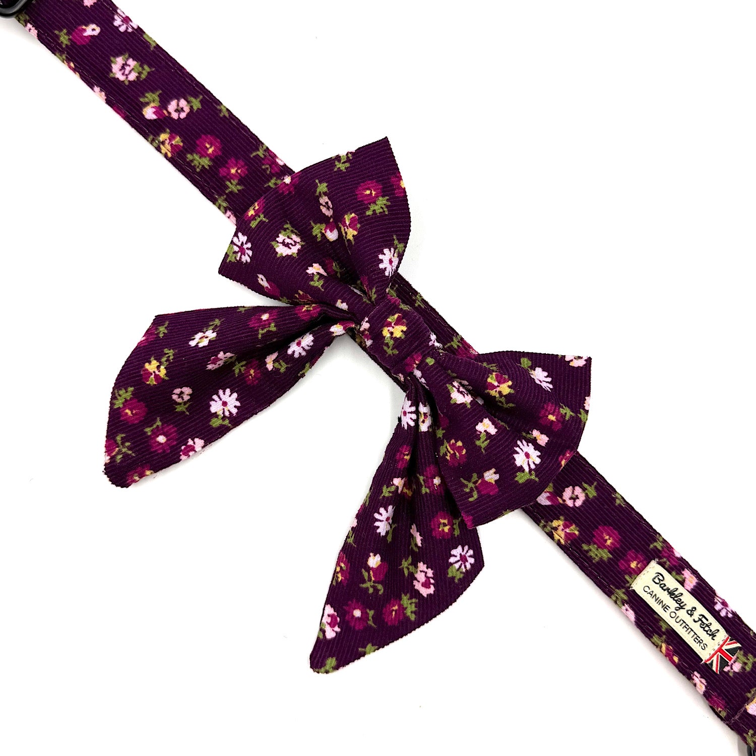 Purple floral-patterned belt with a large bow on a white background