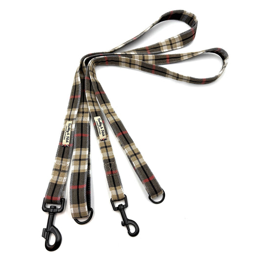 Plaid dog leash with black clip on a white background