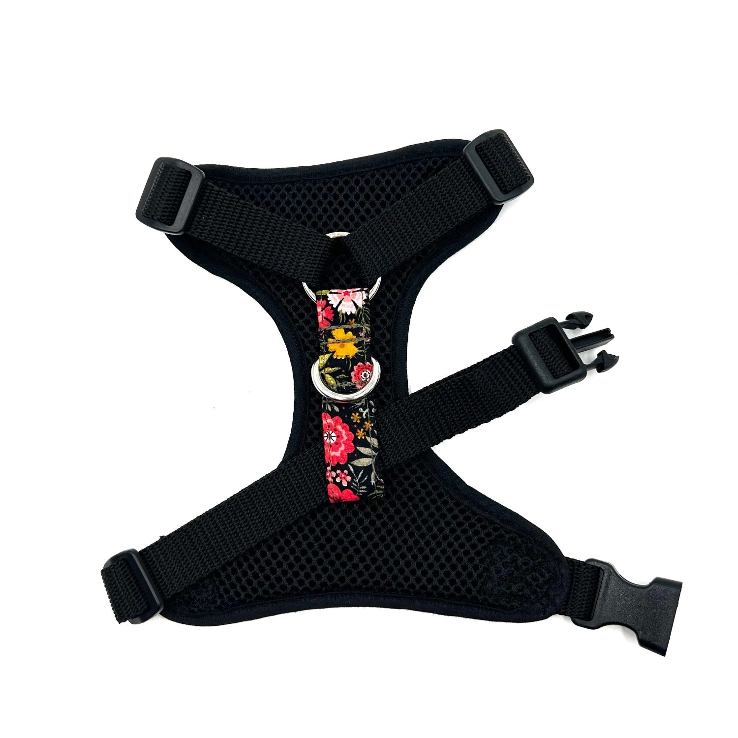 Black dog harness with floral design on a white background