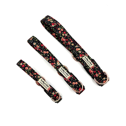 Set of floral-patterned dog collars and leashes on a white background