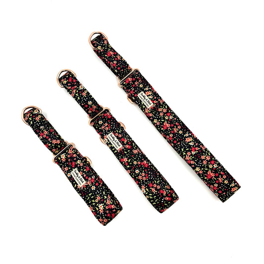 Three floral-patterned straps with gold buckles on a white background