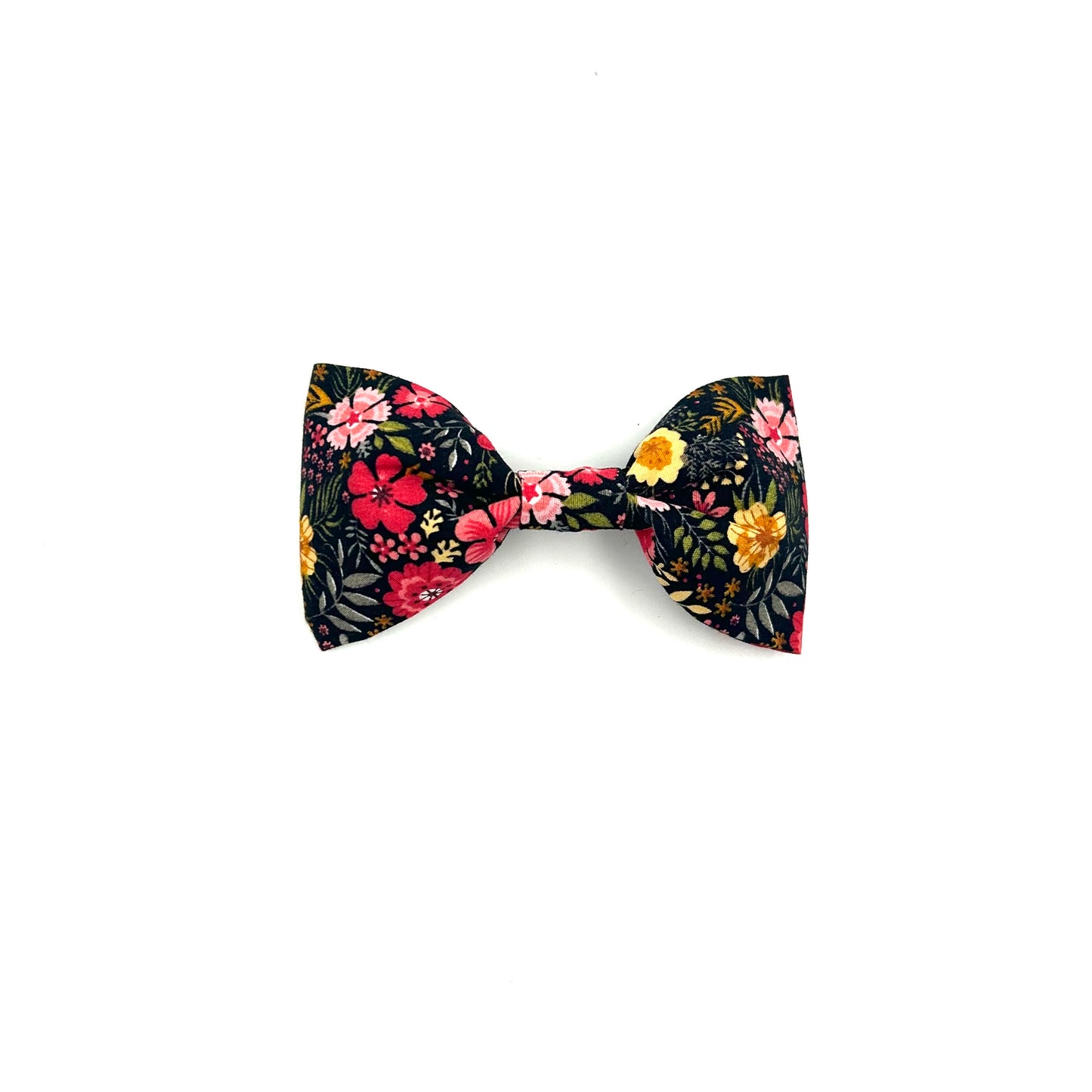 A black dog bow tie with a ditsy floral print, featuring elastic loops for attachment.
