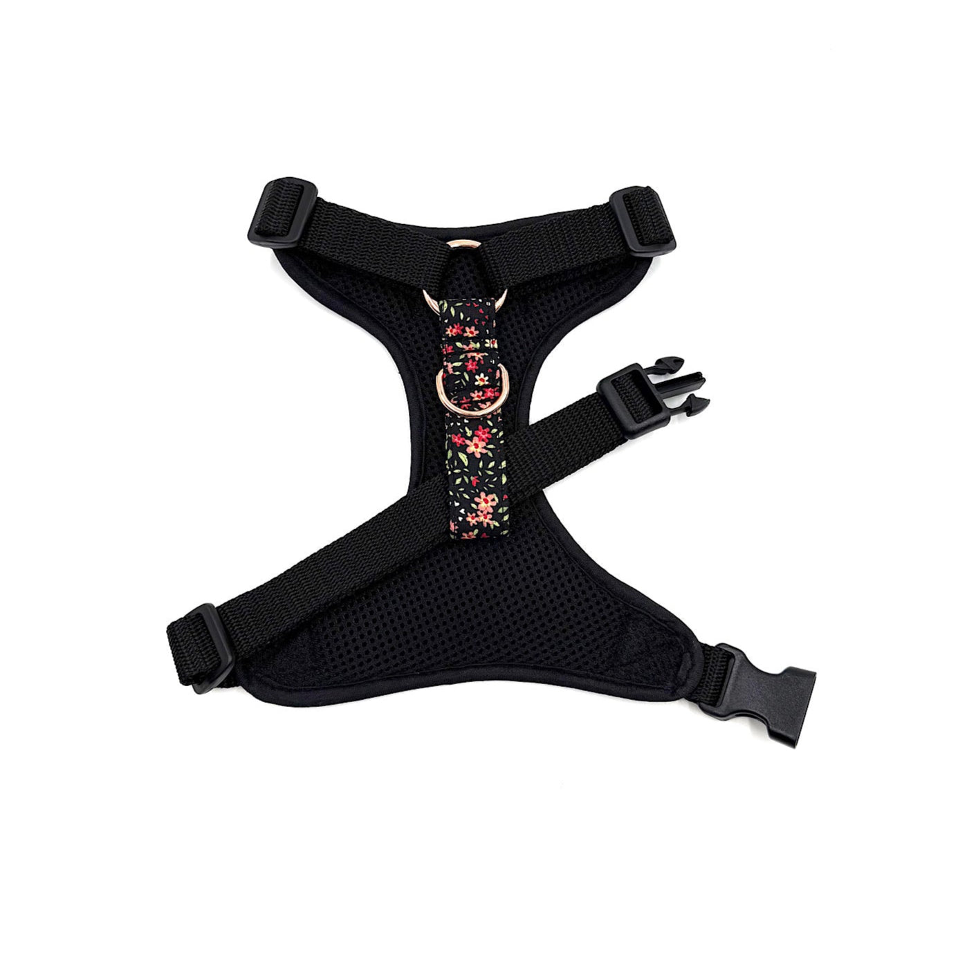 Black dog harness with floral pattern on a white background