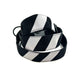 Black and white striped dog collars stacked up on a white background. Handmade in the UK by Barkley and Fetch