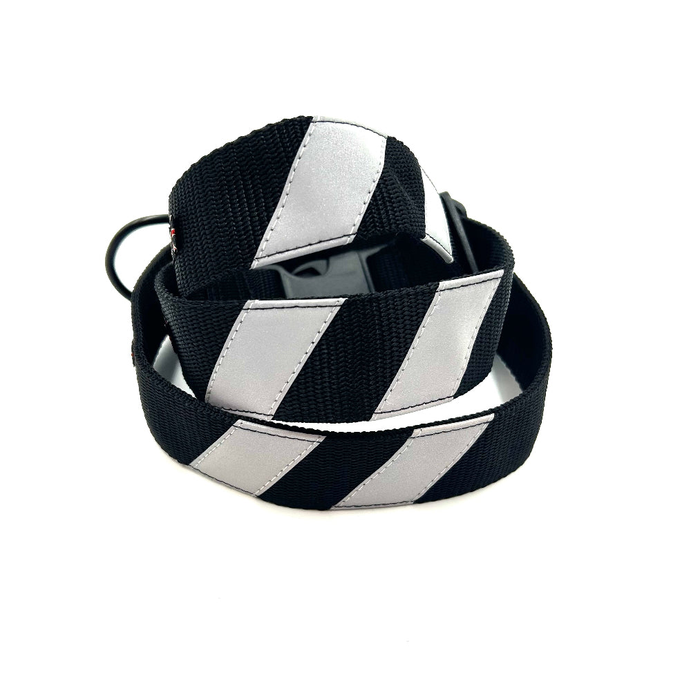 Black and white striped dog collars stacked up on a white background. Handmade in the UK by Barkley and Fetch