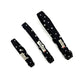 Three black dog collars with star patterns on a white background