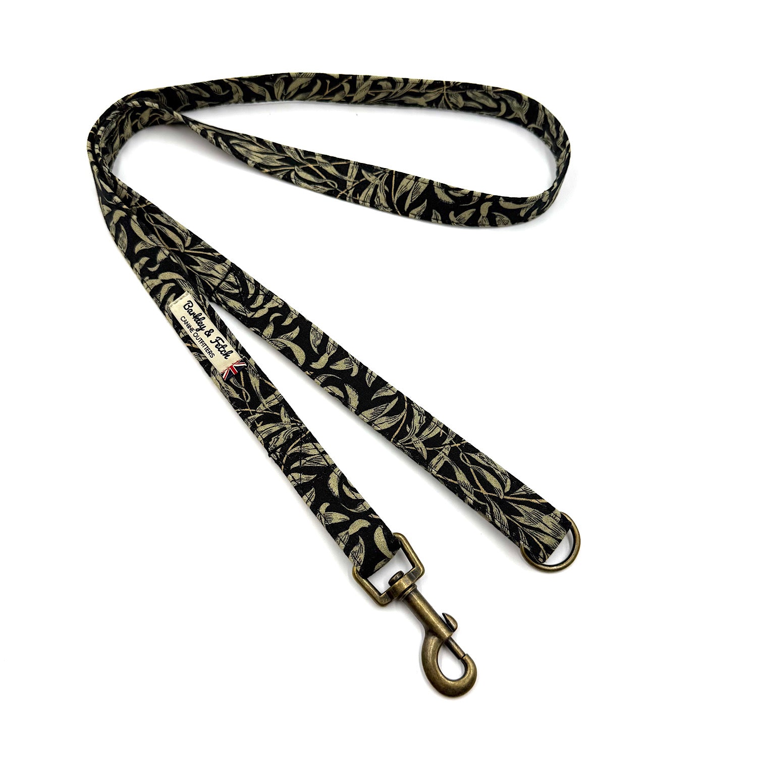 Dog leash with black and gold leaf pattern on a white background