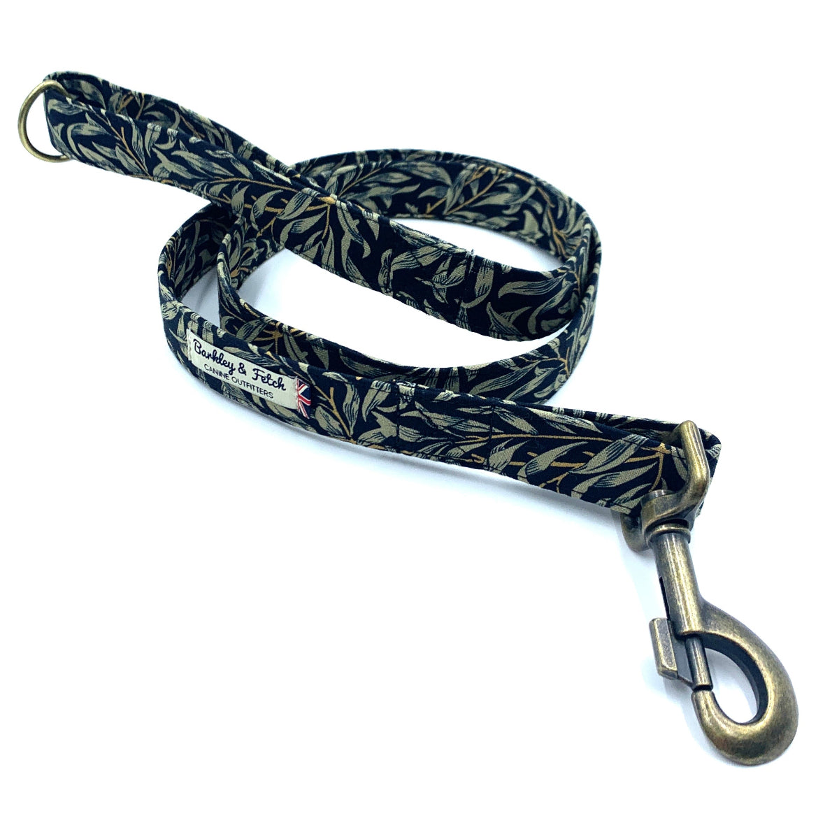 A black and green floral print dog lead with a metal trigger hook and a D-ring on the handle.