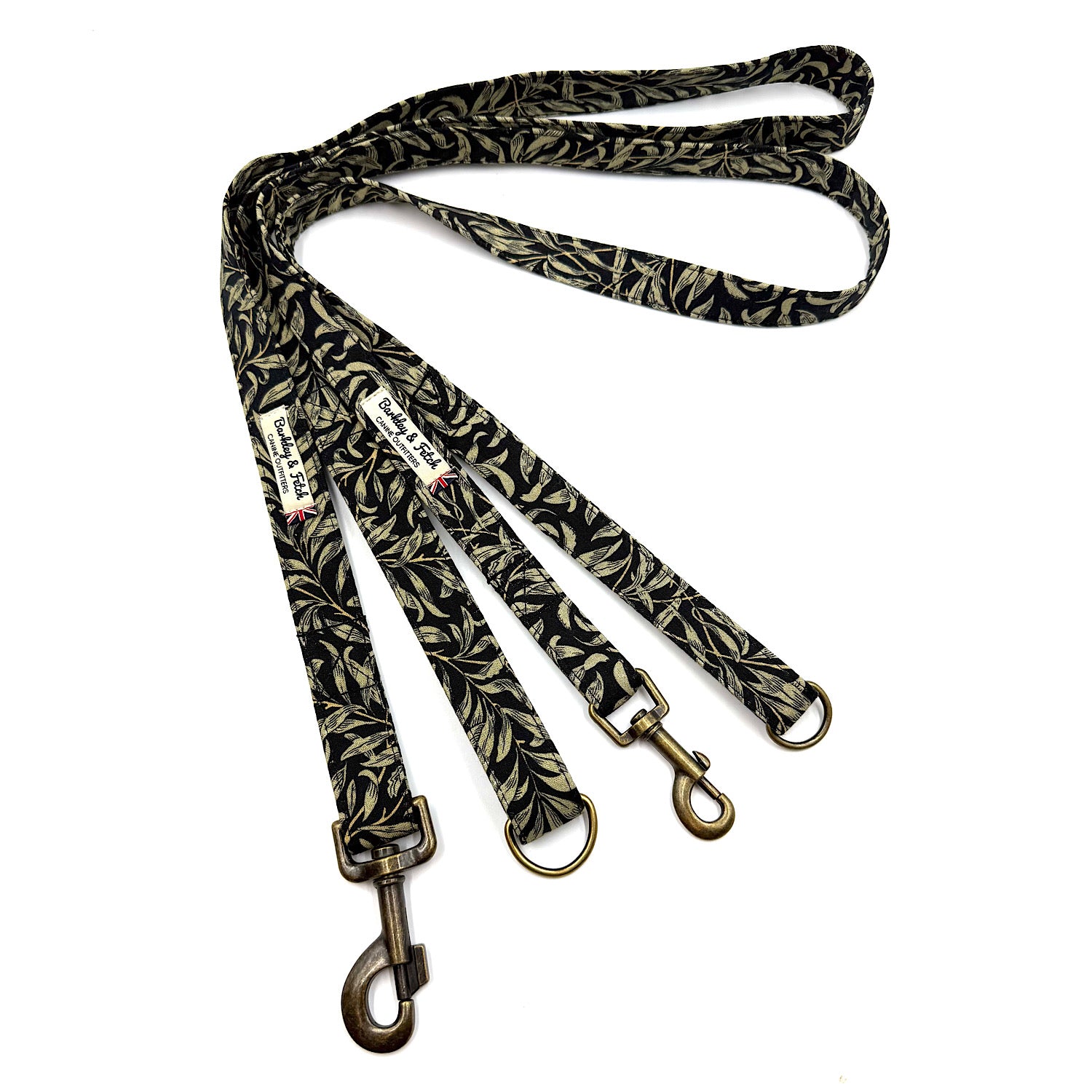 Patterned dog leash with brass hooks on a white background