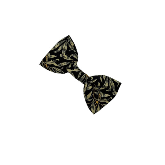 Black and gold patterned bow tie on a white background
