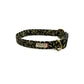 Dog collar with black and gold leaf pattern on a white background