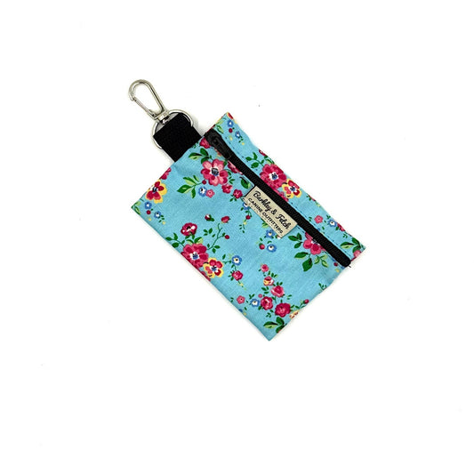Floral patterned keychain pouch with a black zipper on a white background