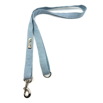 Light blue dog leash with metal clip on a white background