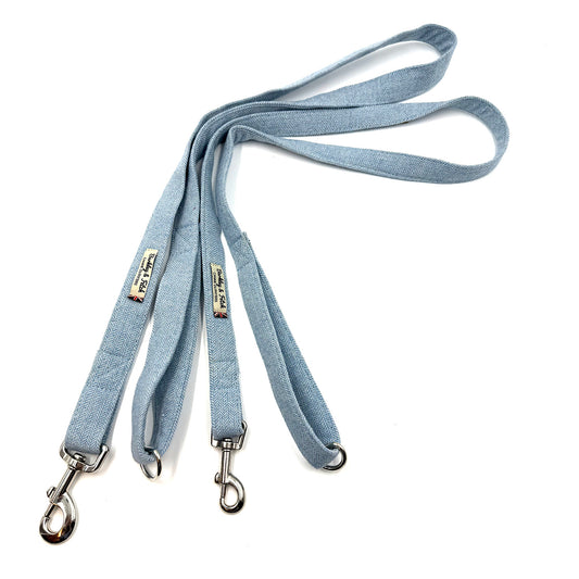 Light blue dog leash with metal clips on a white background