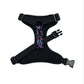 Black dog harness with colorful paisley pattern on a white background