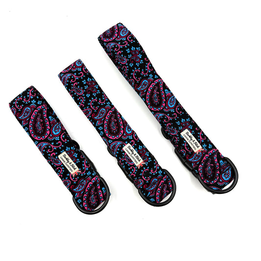 Three paisley-patterned straps with black buckles on a white background