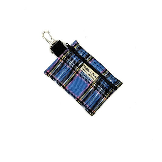Plaid fabric keychain pouch with visible brand name on a white background