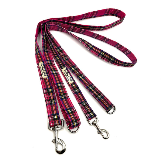 Plaid dog leash with metal clips on a white background