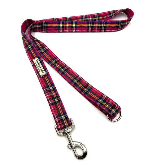 Plaid dog leash with metal clip on a white background
