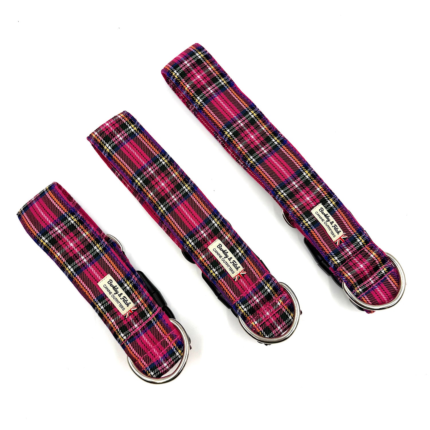 Three plaid dog collars with metal buckles on a white background