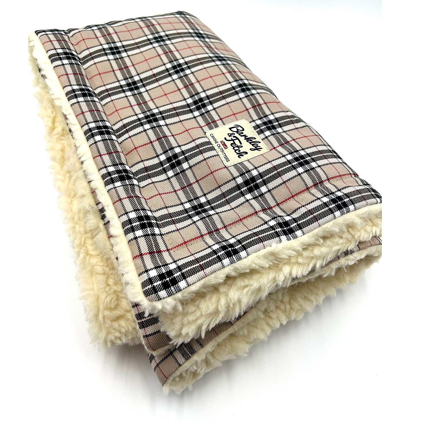 A caramel tartan dog blanket with a plush cream edge, displaying the brand label 'Barkley & Fetch'. handmade by Barkley and Fetch of Great Britain