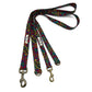 Colorful paisley patterned dog leash with brass clips on a white background