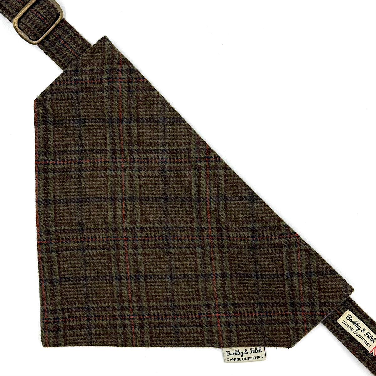 A triangular dog bandana with a brown, black, and red plaid pattern, featuring a matching strap with a brass buckle and a brand label Handmade in Great Britain by Barkley and Fetch.