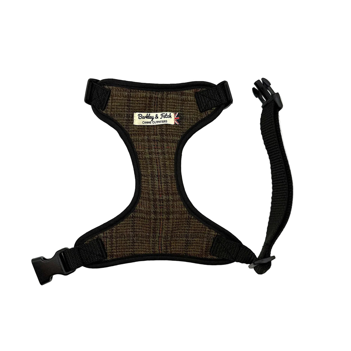 A brown and black plaid dog harness with black nylon trim, adjustable plastic buckles, and a matching black leash attachment strap, shown on a plain white background. Handmade in Great Britain by Barkley and Fetch.