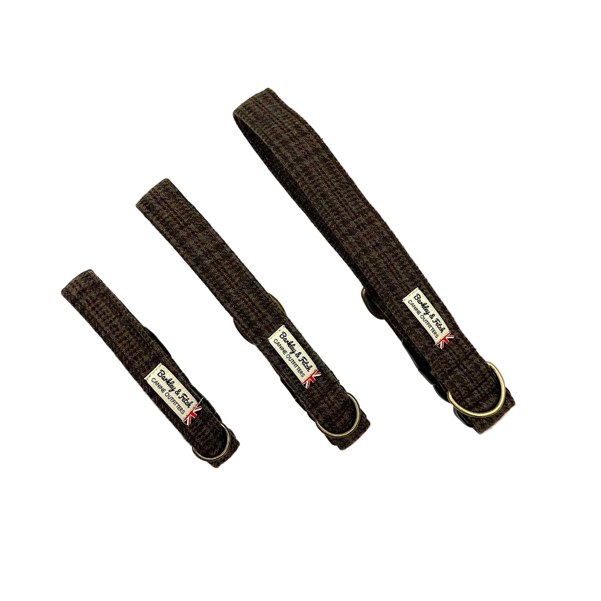 Three dark brown woven fabric dog collars of different sizes arranged diagonally on a white background, each with a brass ring and a brand label. Handmade in Great Britain by Barkley and Fetch.