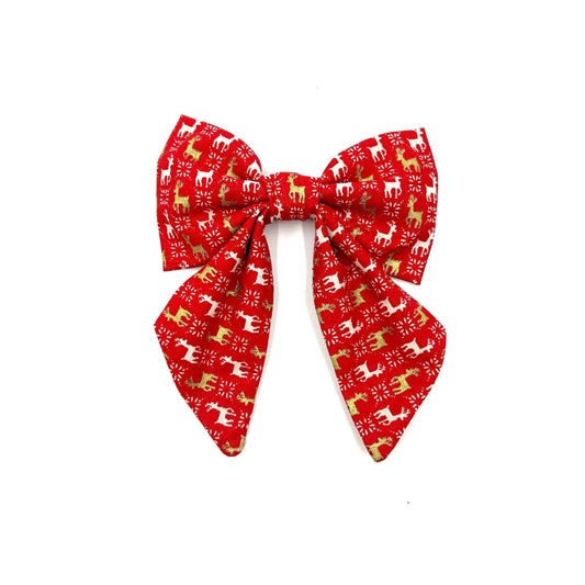 A red and white Christmas-themed dog sailor bow with reindeer patterns handmade in uk by Barkley and Fetch