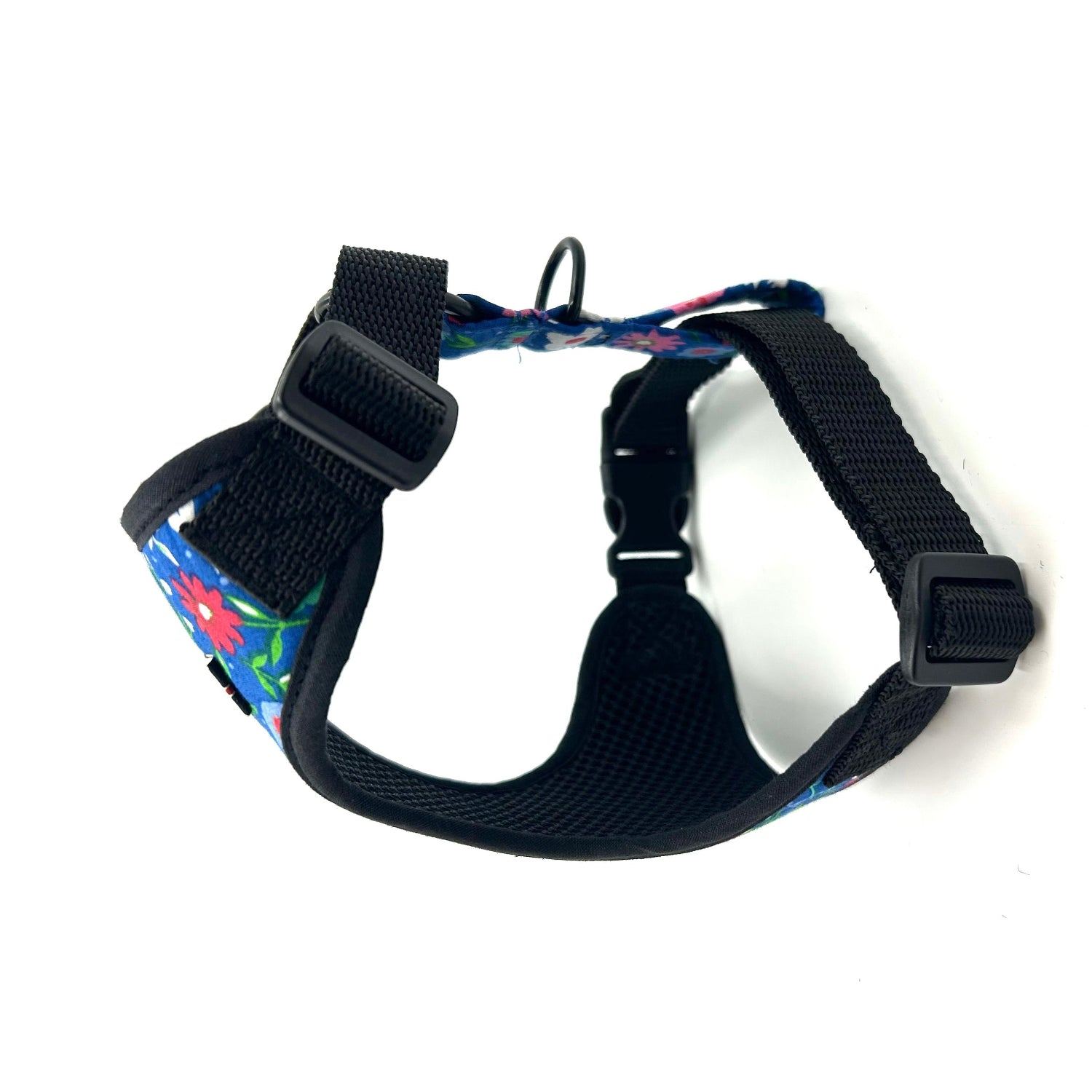 Black dog harness with colorful floral pattern on a white background