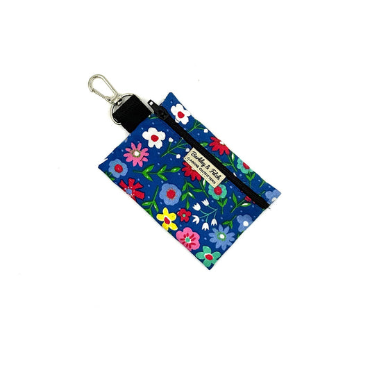 Floral-patterned pouch with keychain on a white background