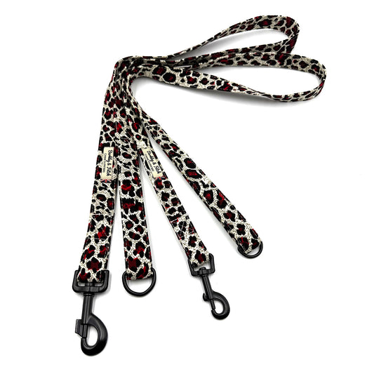 Leopard print dog leash with black clips on a white background