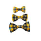 Three plaid bow ties in yellow, black, and blue on a white background